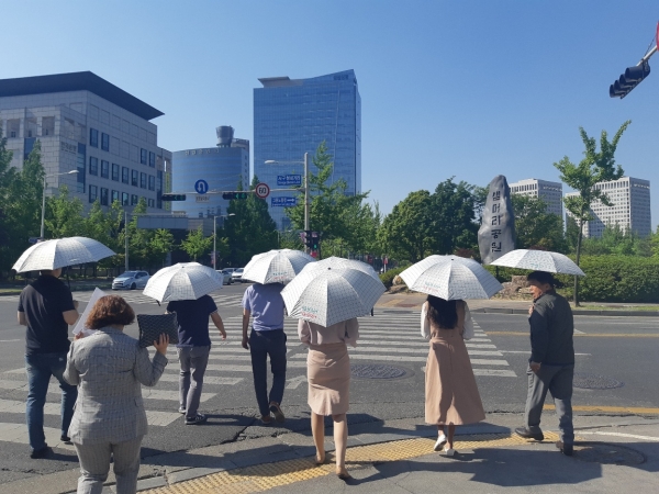 서구청 직원들이 청내에 비치된 양산을 쓰고 관내 출장에 나서고 있다
