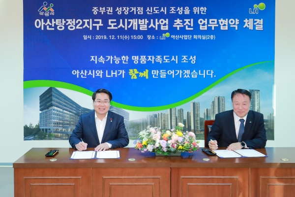 오세현 아산시장이 최화묵 LH 대전충남본부장과 협약서에 서명하고 있다.