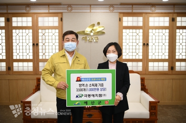 황선봉 예산군수(왼쪽)가 극동에치팜(주)으로부터 코로나19 예방을 위한 손 소독제를 기탁받는 모습