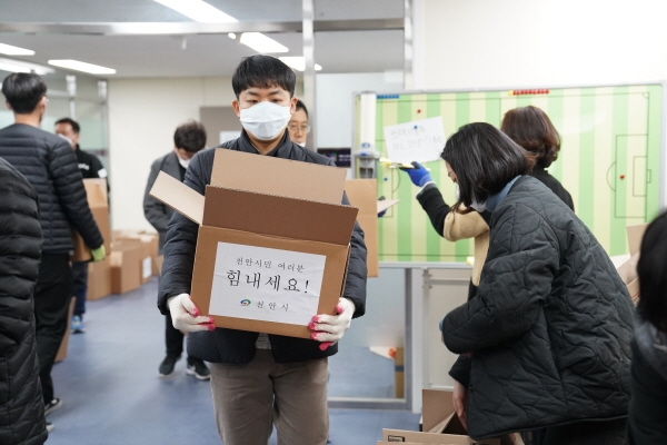 천안시 자가격리 지원팀 전담공무원이 코로나19 격리자 가정의 현관문 앞에 긴급생활용품을 배송하고 있다.