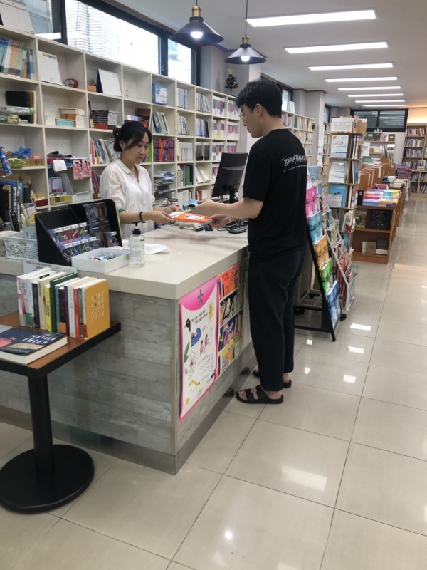 한 시민이 동네서점에서 희망도서 바로바로 대출서비스를 이용하고 있다.