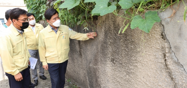 황인호 동구청장이 직원들과 천동 주택가 옹벽을 점검 중이다