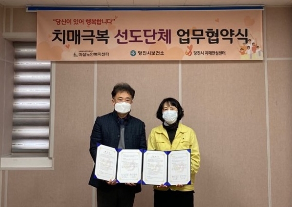 치매극복 선도단체 업무협약식 사진으로 좌)사회복지법인 희망송산 마실노인복지센터 김기창센터장,  우) 당진시보건소 이미숙 보건위생과장