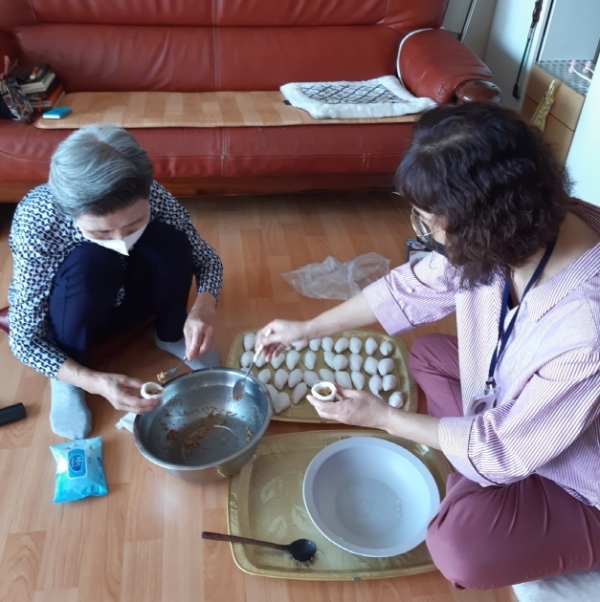 노인맞춤돌봄서비스 대상 어르신과 생활지원사가 송편 만들기 체험 프로그램을 진행하는 모습