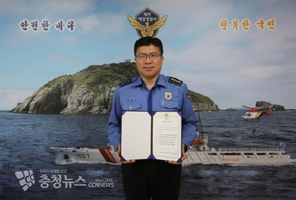 윤태연 서장이 본인이 친필 서명한 ‘대국민 청렴서약서’를 들고 서장실내 ‘안전한 바다, 행복한 국민’ 포토존에서 기념사진을 찍고 있다. / 출처=태안해양경찰서