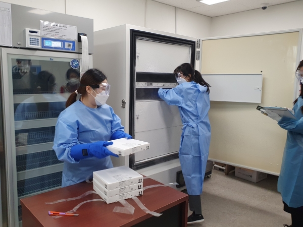 천안시 보건소 관계자들이 화이자 백신을 냉장고에 옮겨 담고 있다.