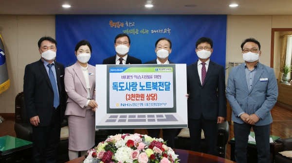 NH농협은행 대전영업본부 임직원들이 노트북을 전달하며, 기념촬영을 하고 있다.(왼쪽에서 두 번째가 NH농협은행 대전영업본부장 김동수)