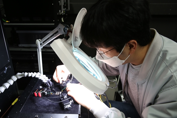 연구원이 효율 측정을 위해 태양전지 샘플을 솔라시뮬레이터 거치대에 올려 준비하고 있다.