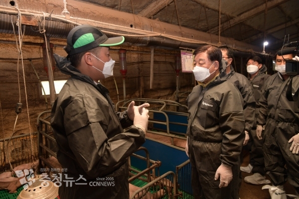황선봉 군수가 듀록돼지 사육농가를 방문해 설명을 듣는 모습