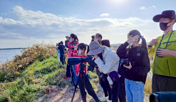 지난해 11월 천수만 간월호에서‘2021 천수만 철새학교 참여자들’이 망원경으로 철새들을 관찰하는 사진(사진제공 - 천수만생태관광협의회 생태관광해설사 지인숙)
