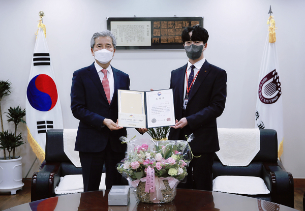 24일 오전 목원대 대학본부 4층 총장실에서 열린 교육부 장관 표창 전수식에서 김시환 담당(오른쪽)이 권혁대 총장으로부터 표창장을 전달받으며 기념촬영