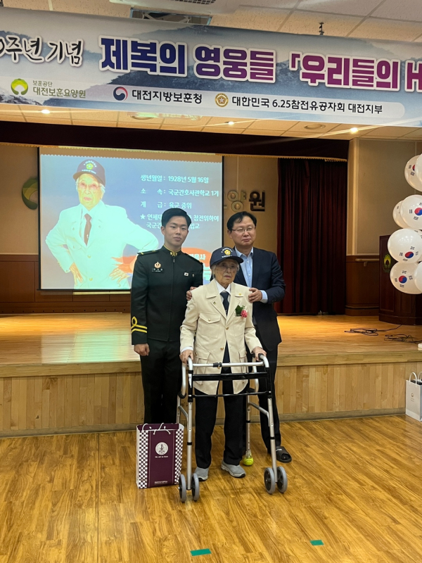 강만희 대전지방보훈청장(우)과 국군간호사관학교 생도(좌)가한영숙 6‧25참전유공자에게 뱃지와 모자를 전달 후, 기념사진을 촬영하고 있다