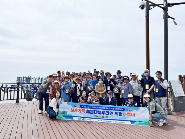 국가철도공단 관계자들과 국가유공자 가족들이 26일 해운대 블루라인 다릿돌 전망대에서 기념촬영