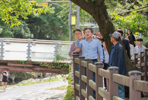 지난 10일 진행된 온천2동 현장 행정에서 정용래 유성구청장이 학사마을 인근 유성천 데크 정비공사 현장의 진행 상황을 점검하고 있다