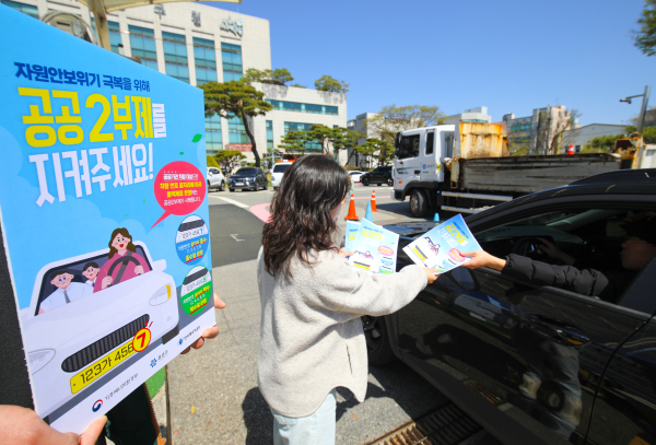 유성구청 직원이 구청 출입 차량에 공공2부제 홍보물을 배부하고 있다.