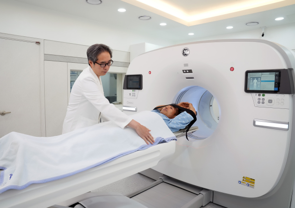 단국대병원 핵의학과장 이재현 교수가 새로 도입된 PET-CT 검사를 위해 환자의 위치를 조정하고 있다